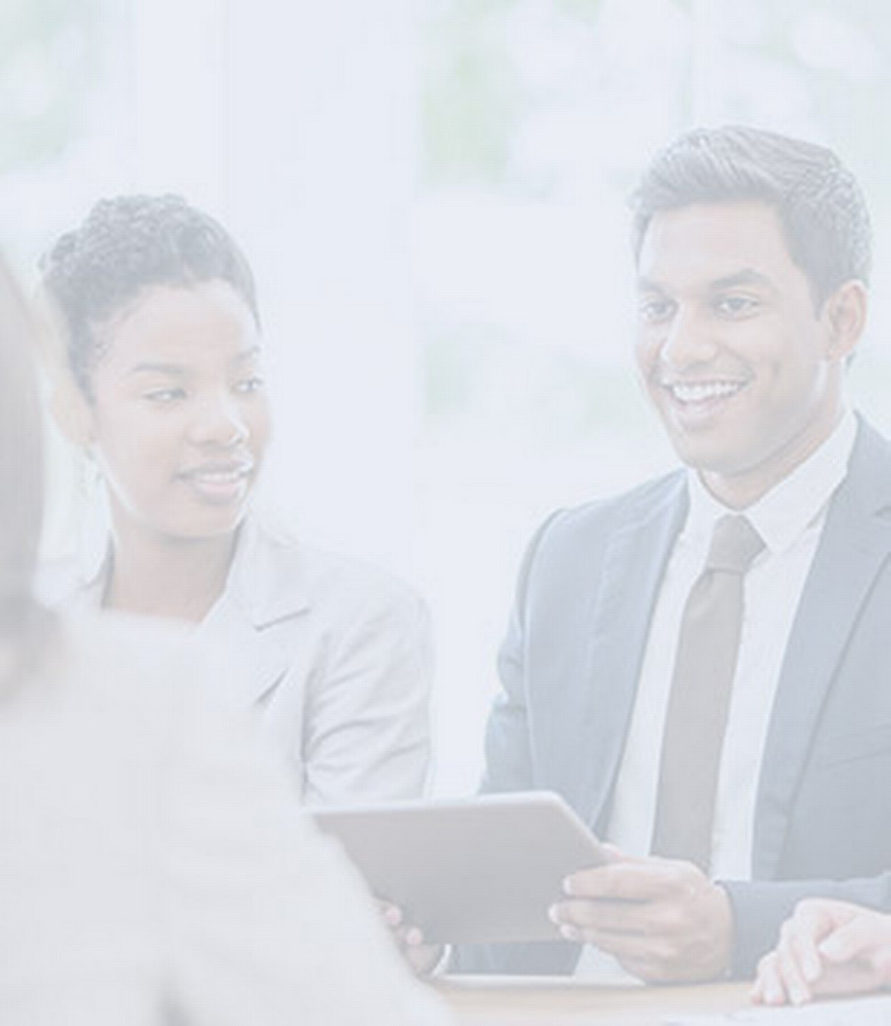 A multi-ethnic group of business professionals are working together at the office.