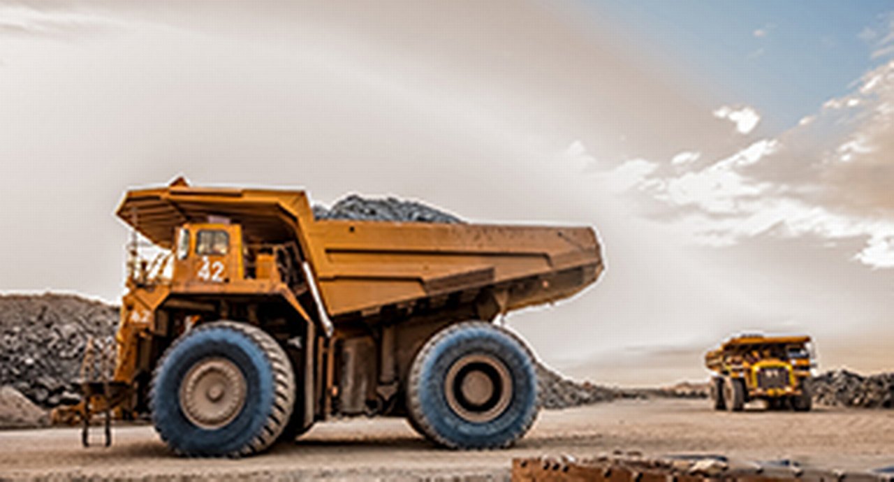 Dump trucks transporting platinum ore for processing