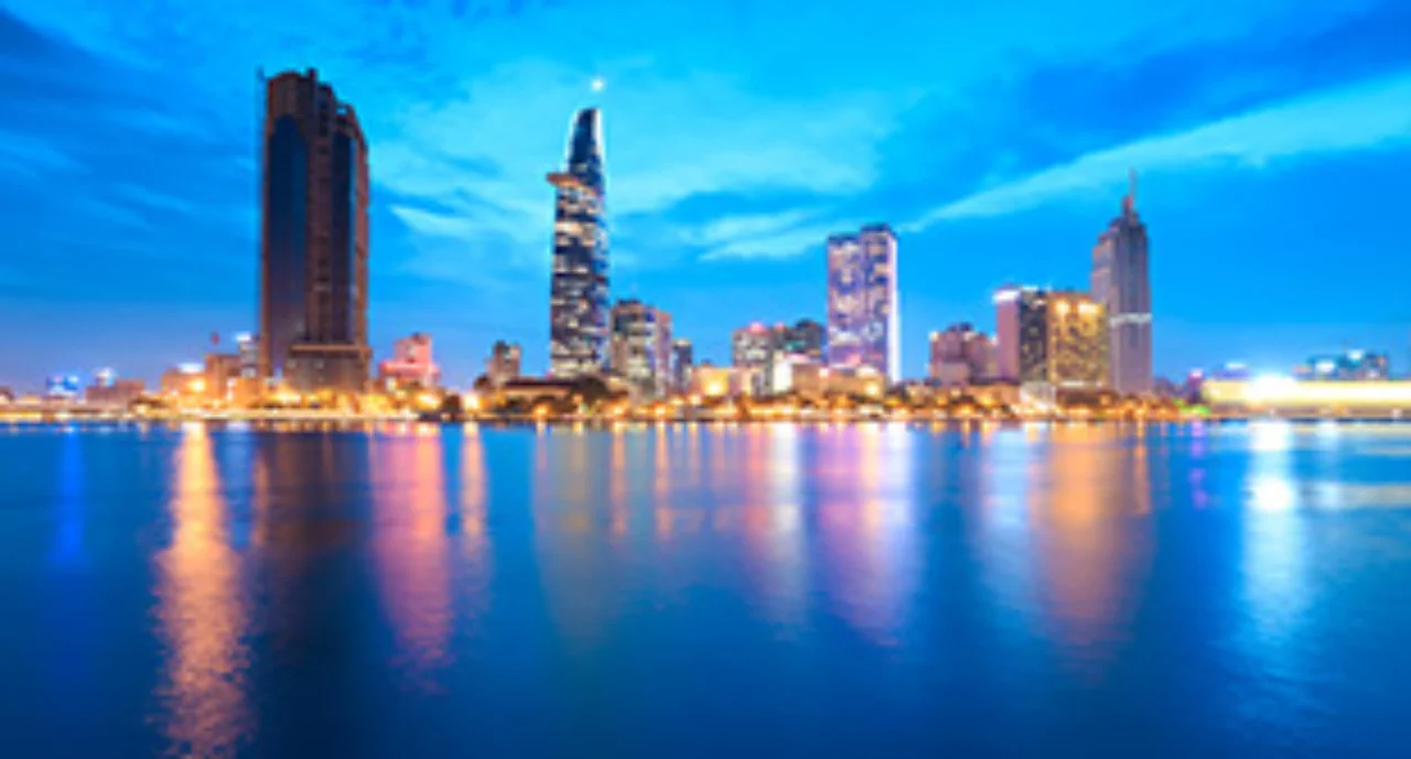 Downtown Saigon skyline in twilight with the sea in the foreground