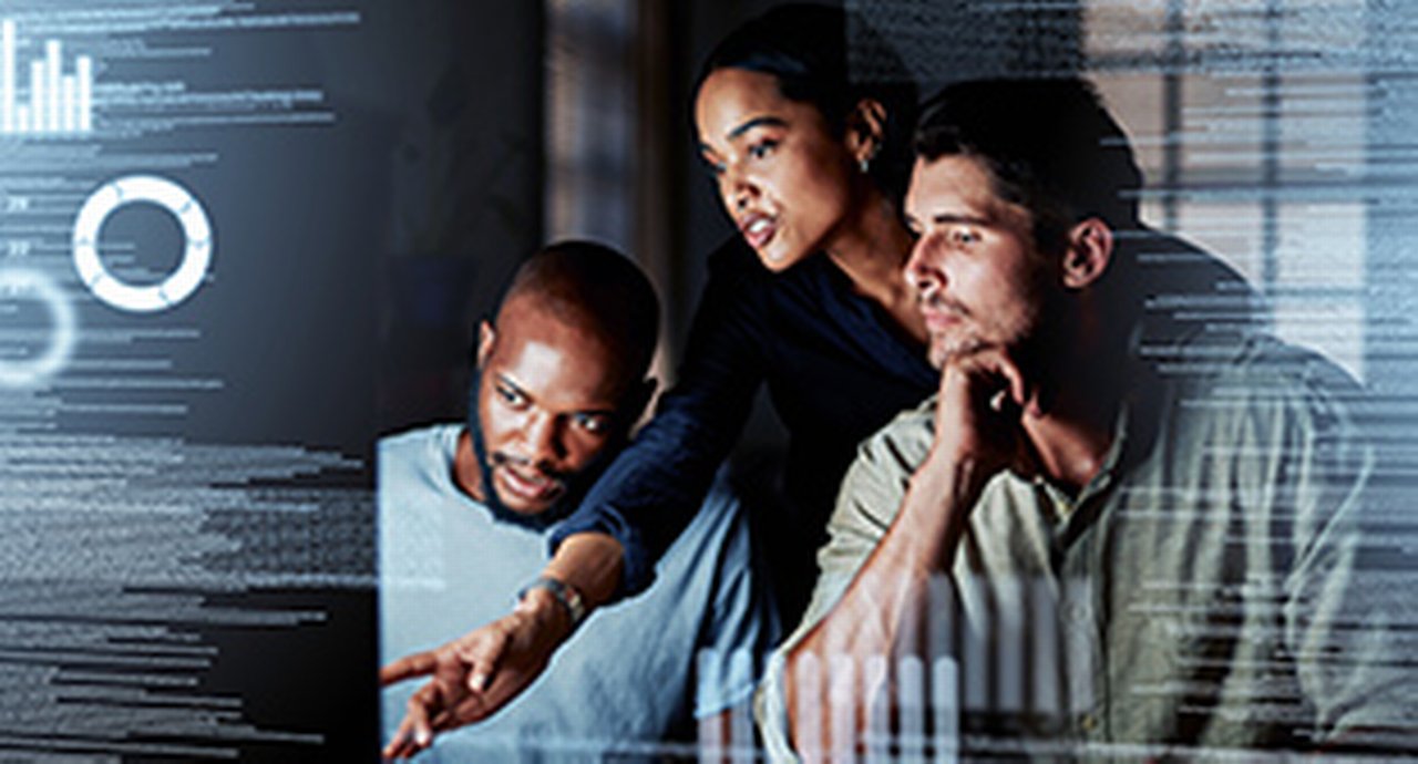 three you people on the right are looking at a desktop in the middle of the picture next to code lines at the very left