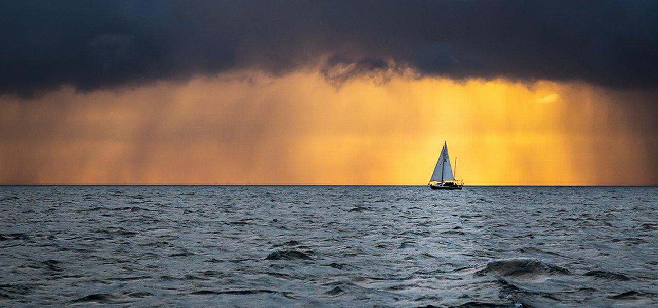Boat Sailing Into The Storm