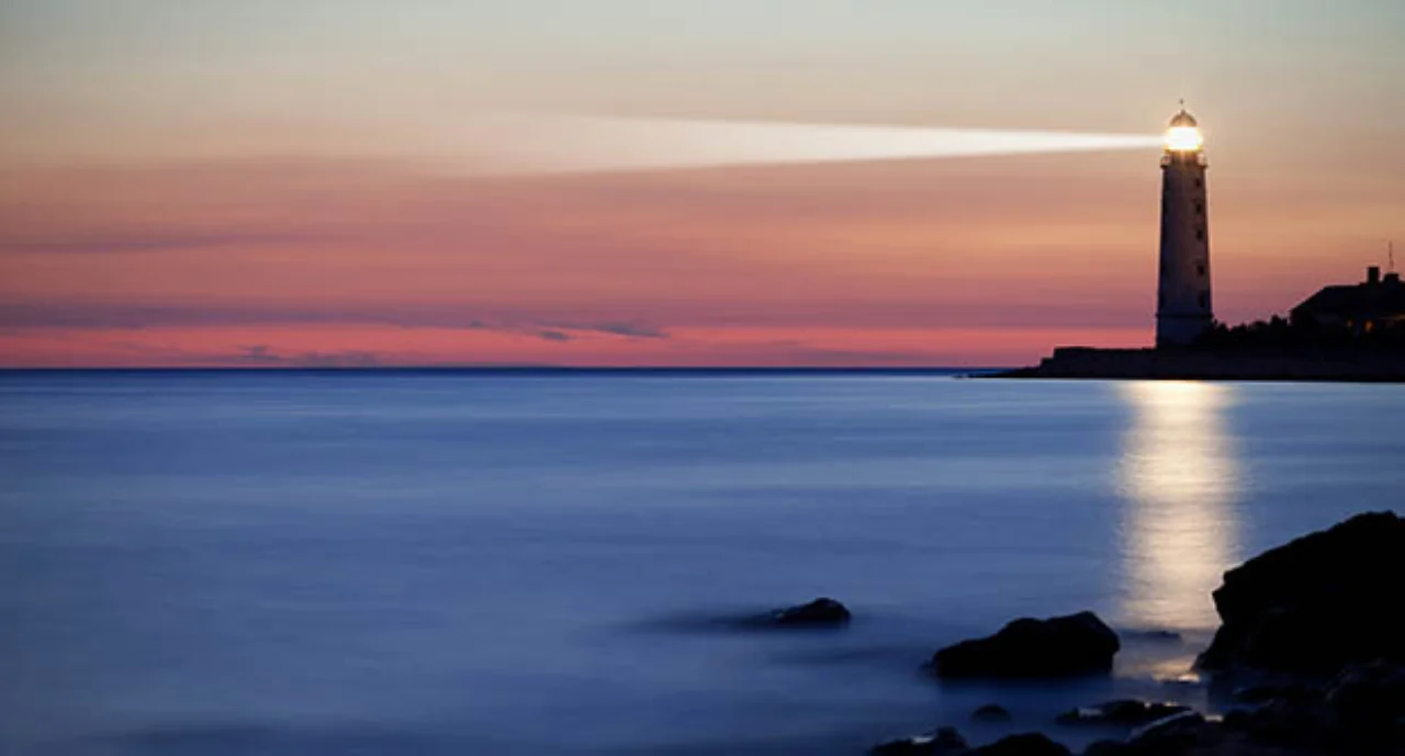 A lighthouse on the coast during dusk