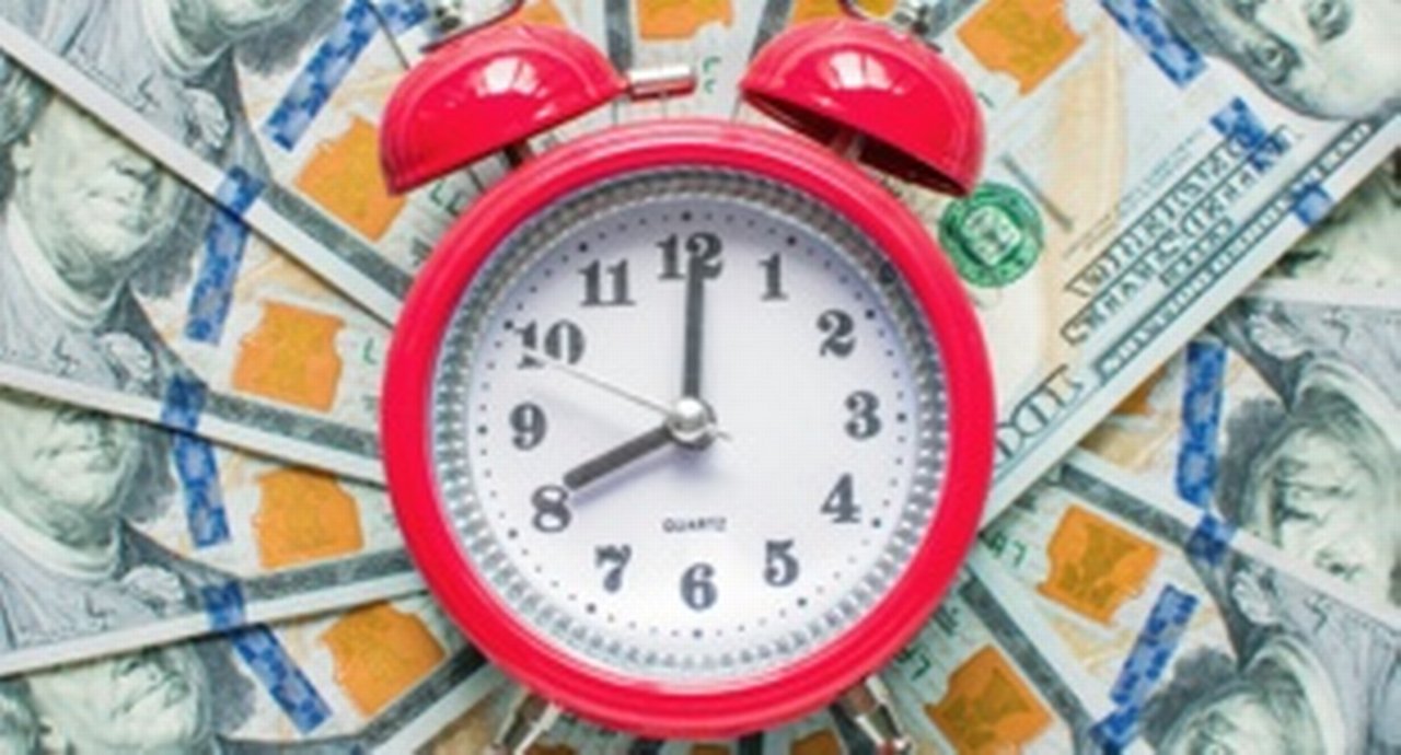 A layer of money with a clock in the middle