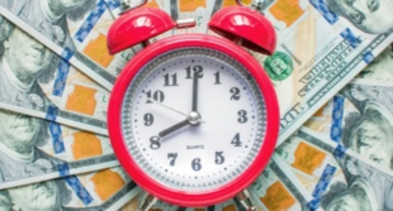 A layer of money with a clock in the middle