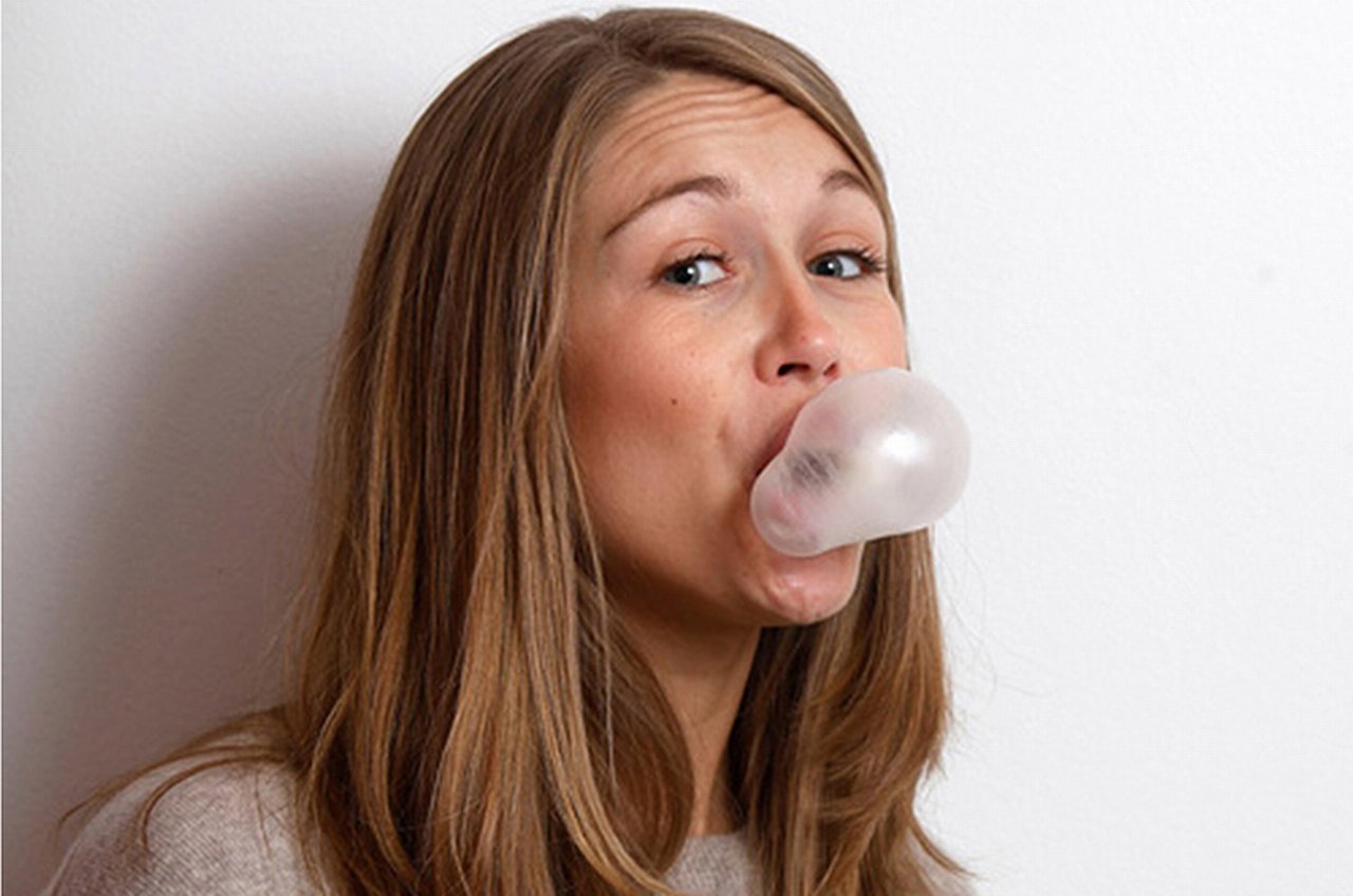 A Girl making a bubble with chewing gum