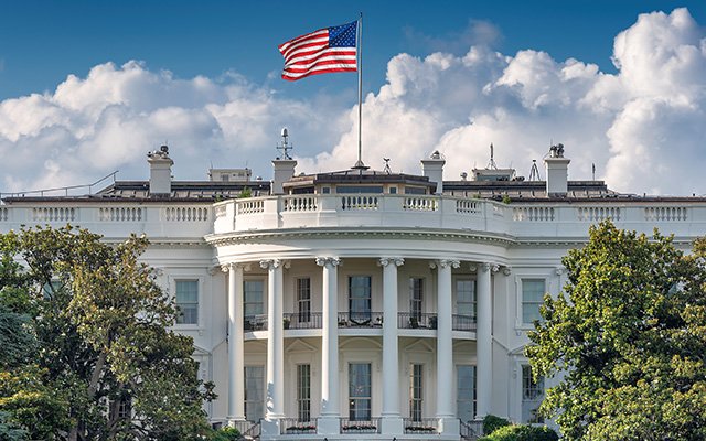 The US  White house with an american flag waving on top