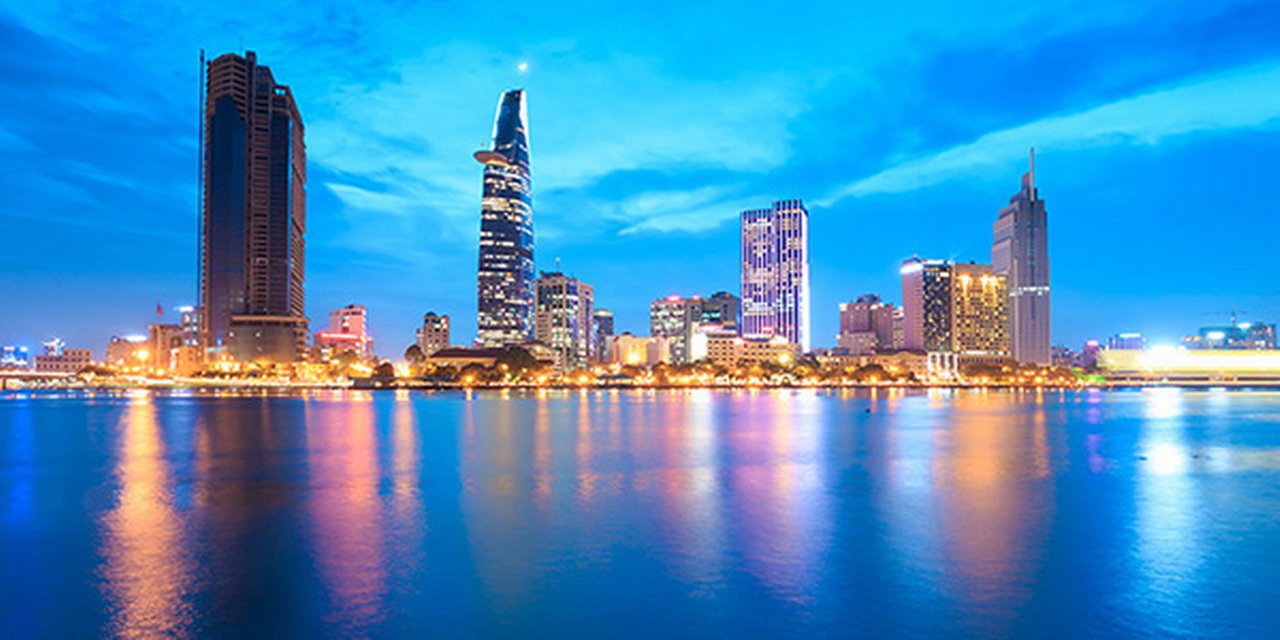 Downtown Saigon skyline in twilight with the sea in the foreground