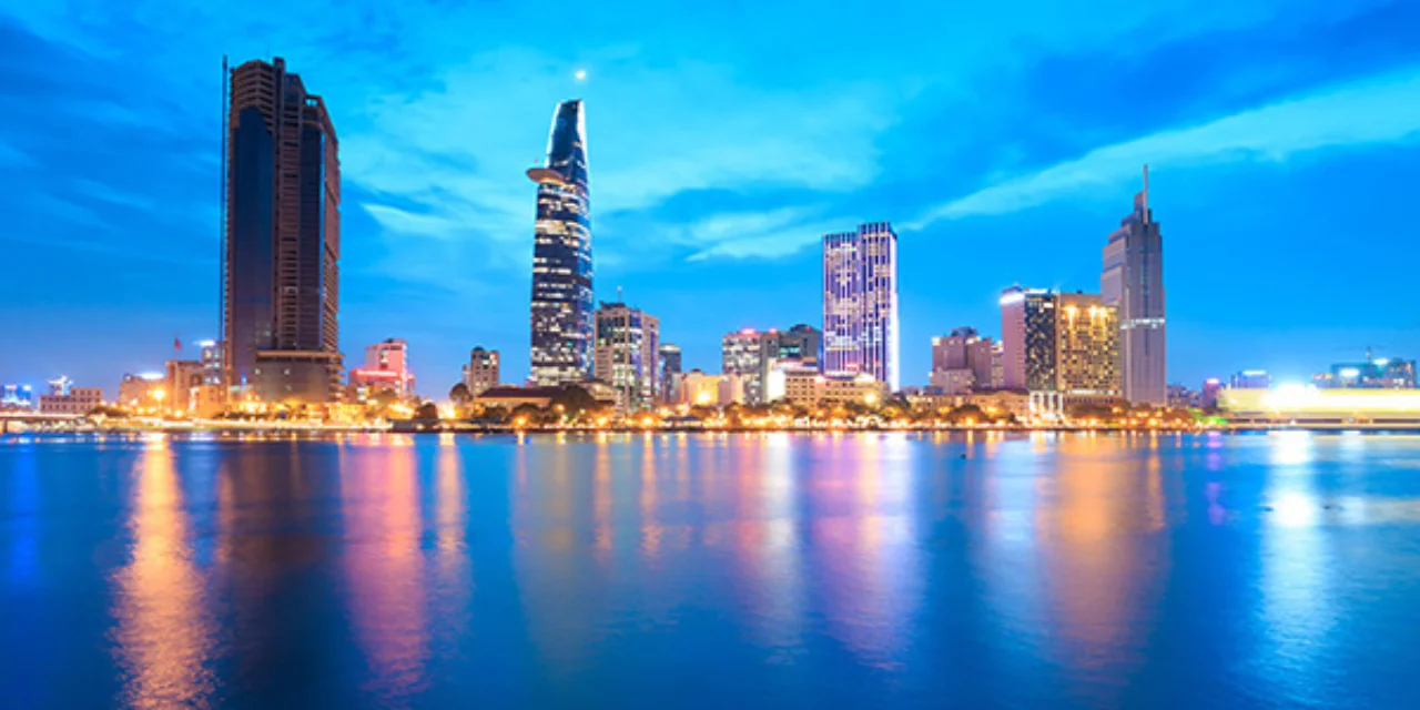 Downtown Saigon skyline in twilight with the sea in the foreground