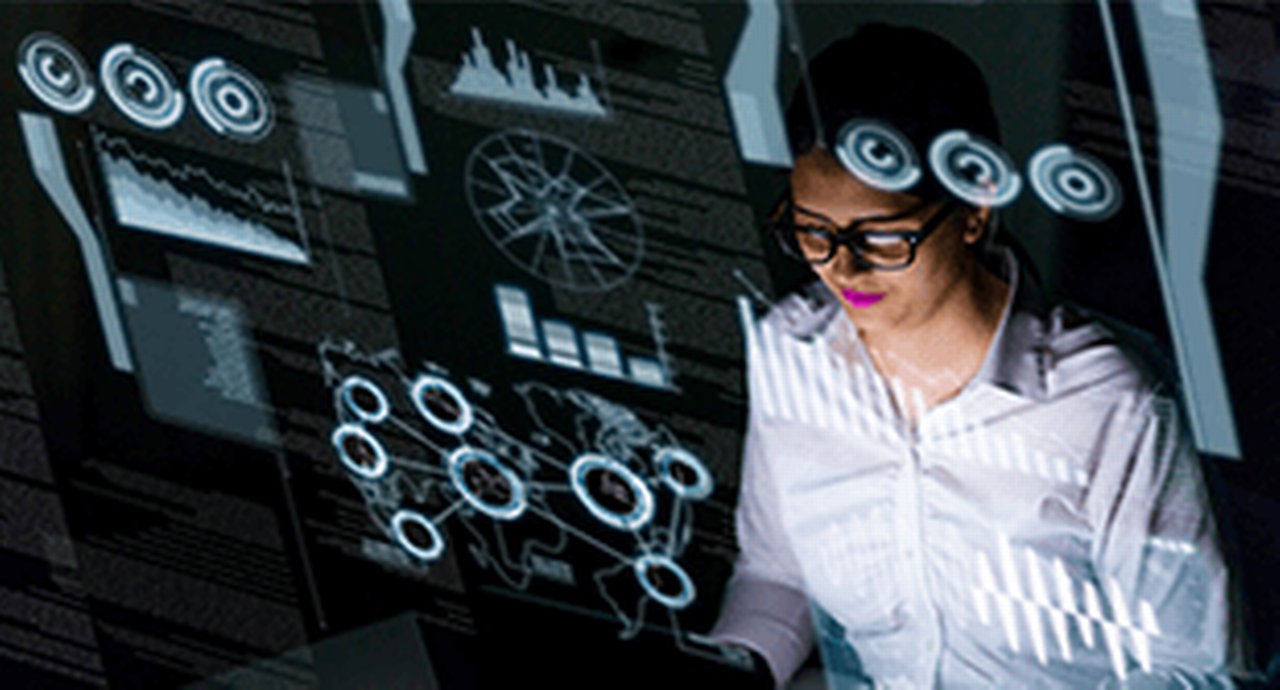 womans head wearing glasses in front of computer graphics and texts