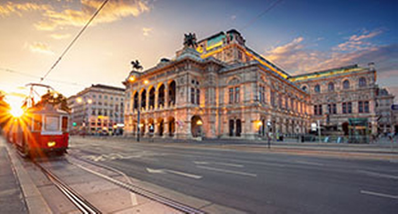 Cityscape image of Vienna with the Vienna State Opera during sunset.