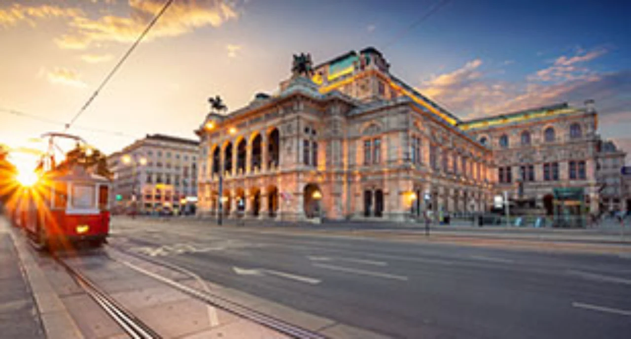 Cityscape image of Vienna with the Vienna State Opera during sunset.