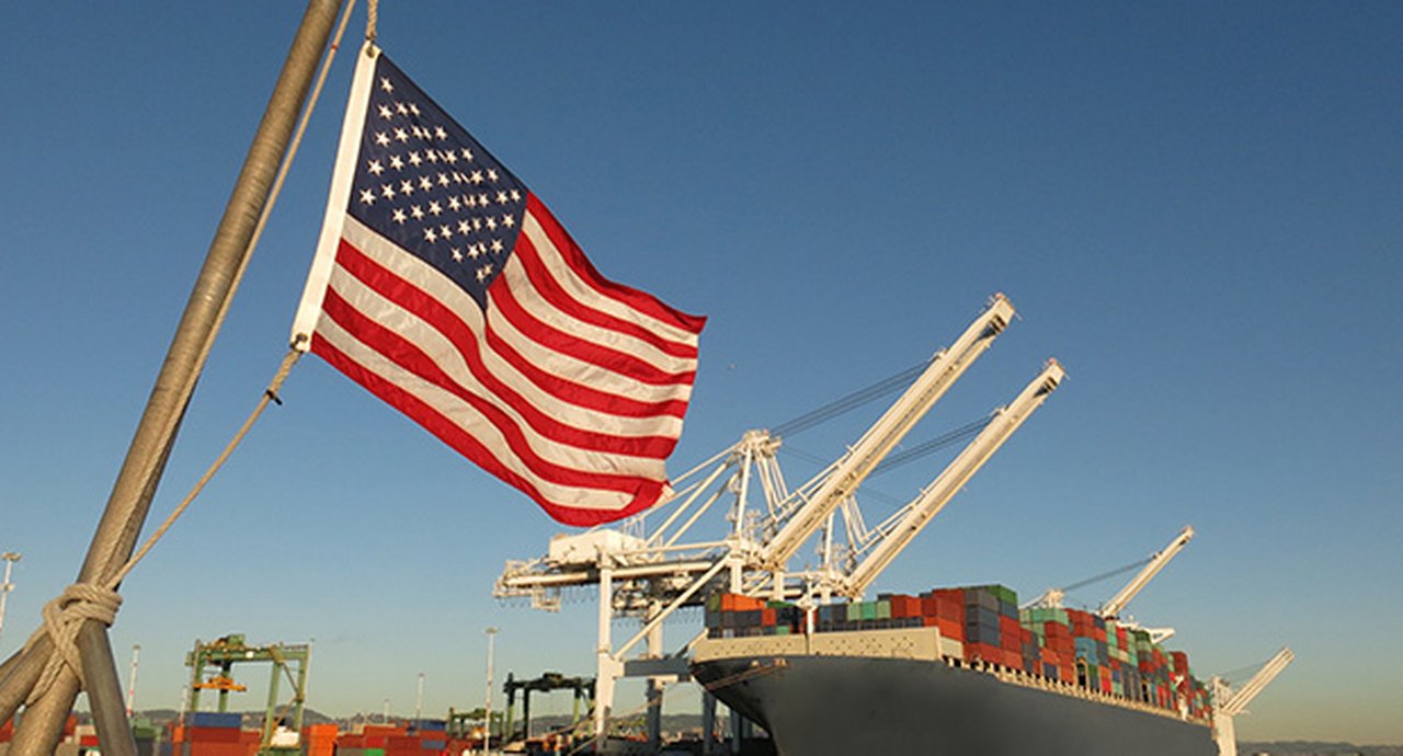 American flag next to a port container ship