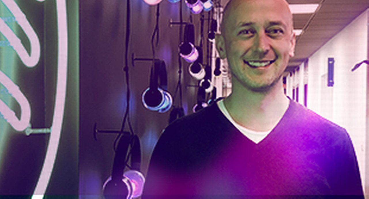 Spotify's treasurer Patrik Hallerström in front of a wall on which illuminated headphones hang