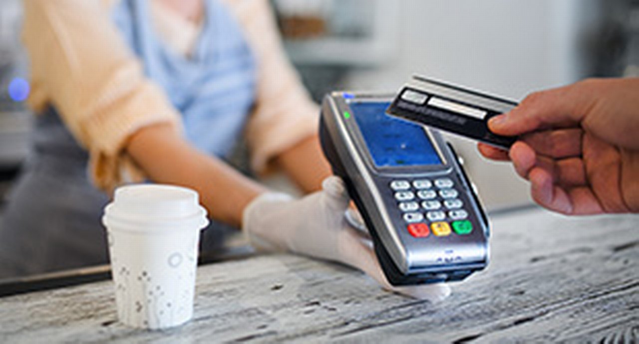 Contactless payment with debit card, coffee shop open after lockdown