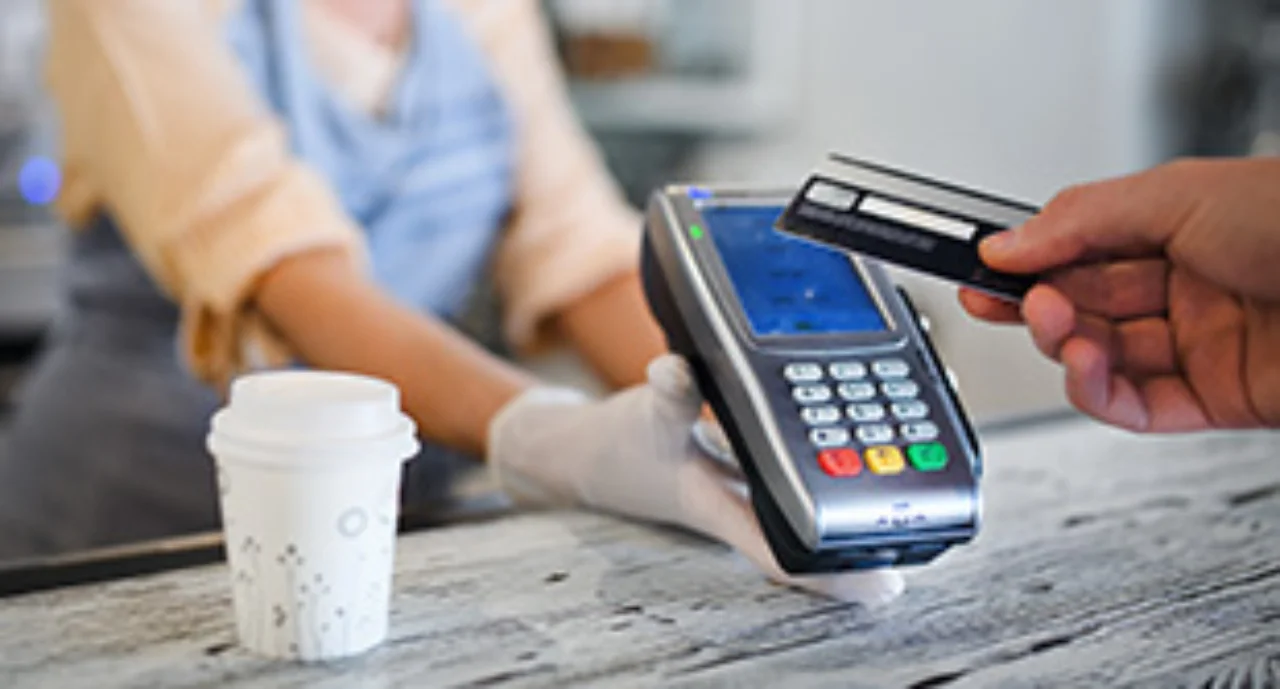Contactless payment with debit card, coffee shop open after lockdown