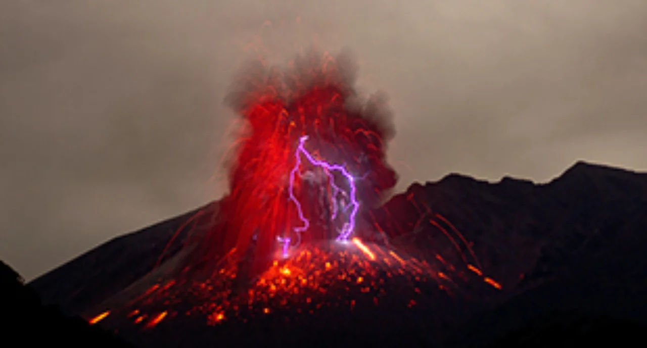 An erupting volcano in vivid red and with magenta lighting