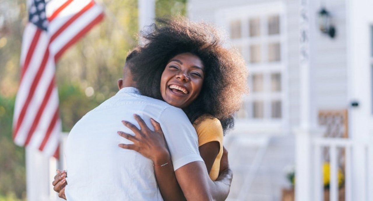Woman Welcomes Her Husband On The Porch