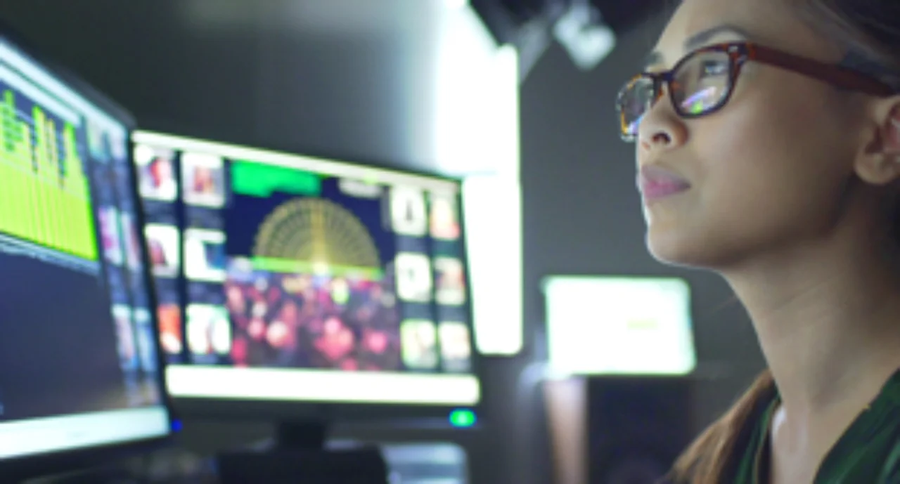 A professional trader monitors her screens