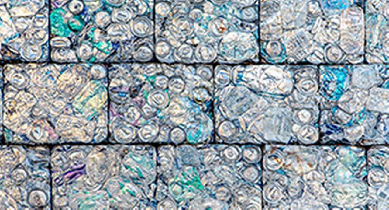 A wall of crushed aluminum cans recycled into building blocks