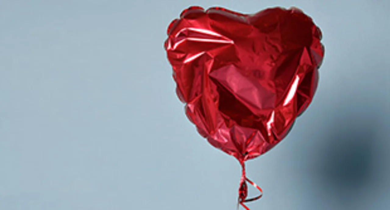 Deflated red heart balloon