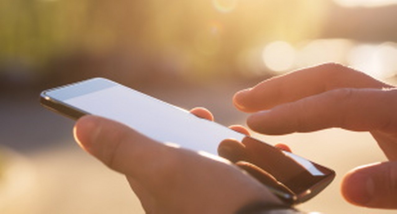 Hands working a mobile telephone