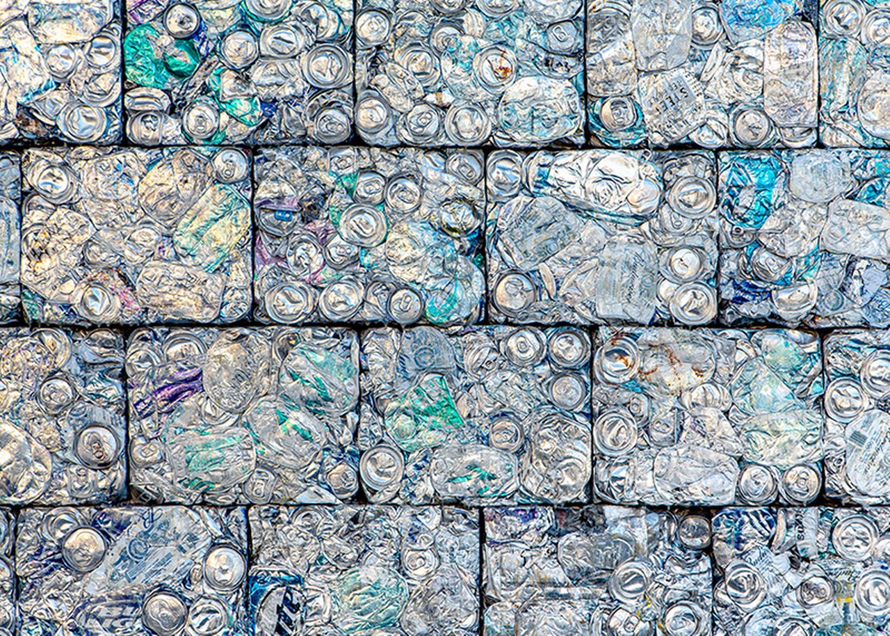 A wall of crushed aluminum cans recycled into building blocks