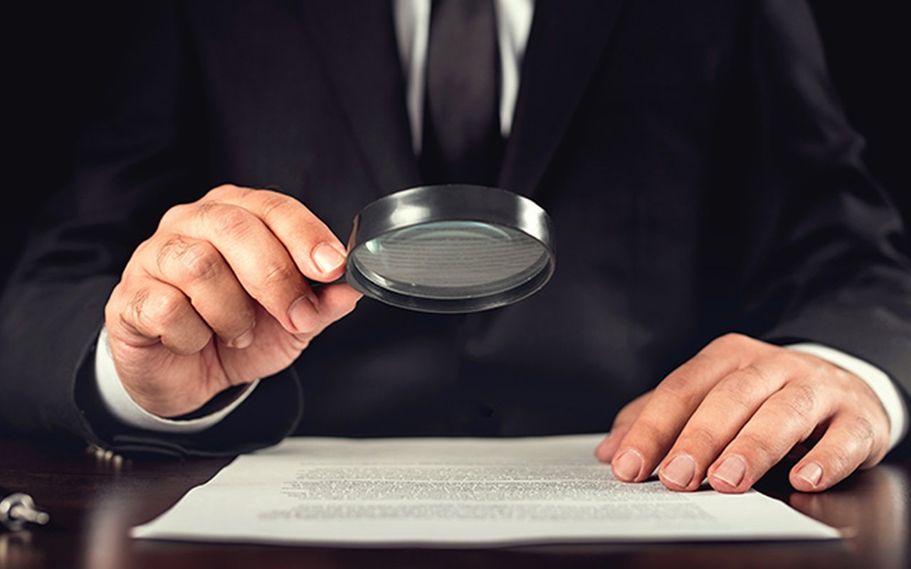 Businessman reading contract details before signing