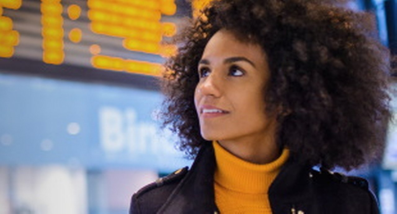 Woman standing in front of a digital board