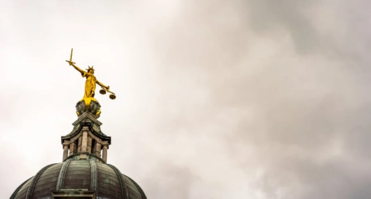lady justice facing a stormy sky