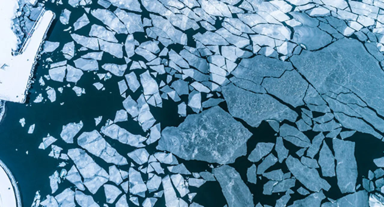 Big Cracked ice floe floating on baltic sea in Helsinki finland.