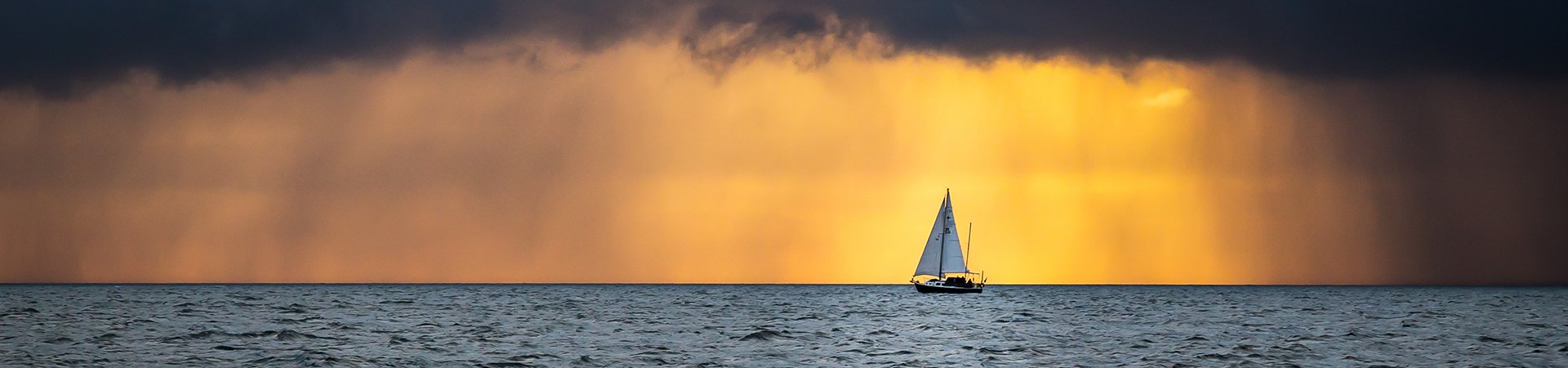 Boat Sailing Into The Storm