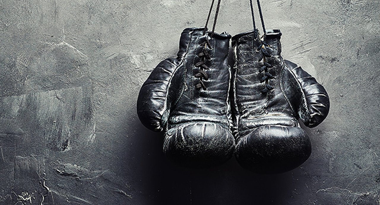 Old Boxing Gloves Nailed To The Textured Wall