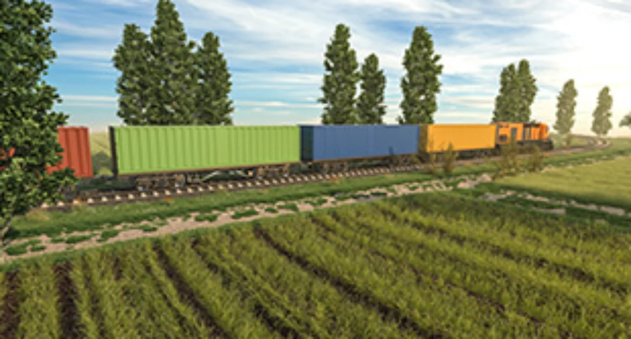 Train boxcars on a green field with trees