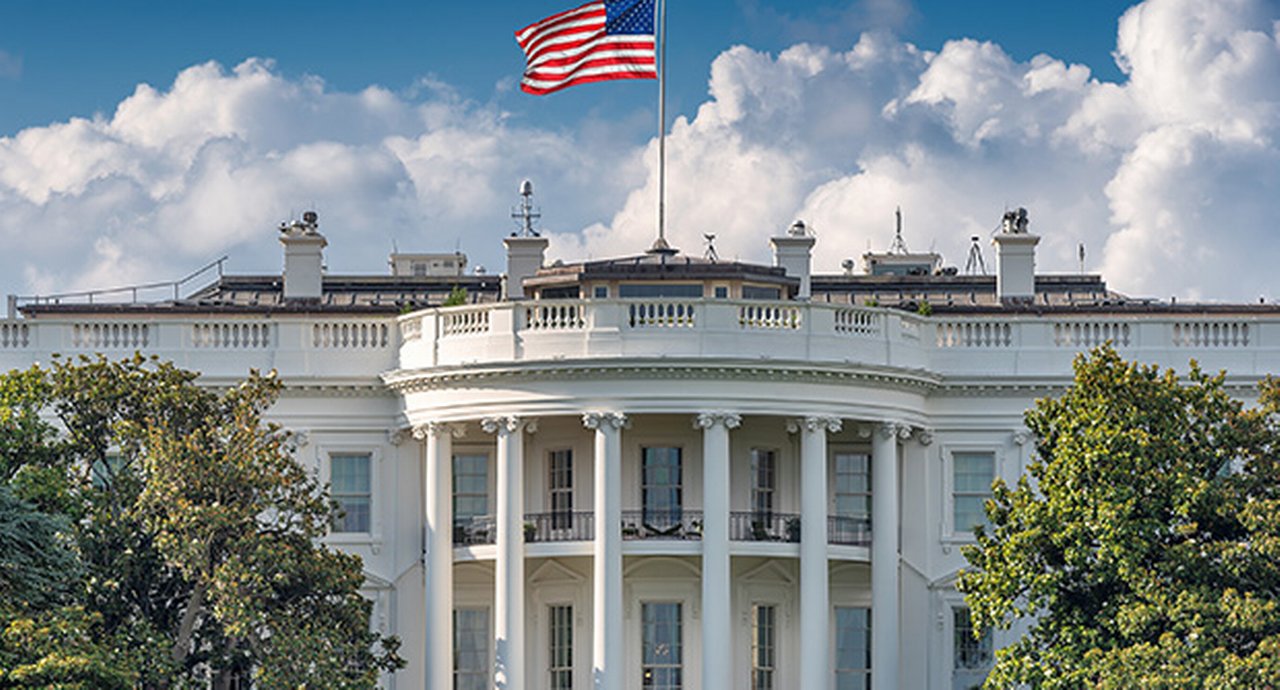 The US  White house with an american flag waving on top