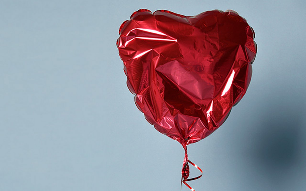 Deflated red heart balloon