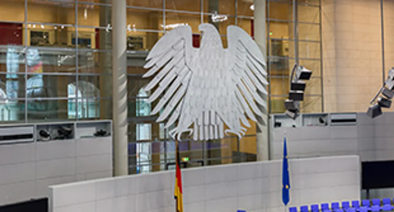 View on interior of the empty plenary hall of the German Federal Parliament (Deutscher Bundestag). In the middle the german coat of arms (eagle, so-called Bundesadler)