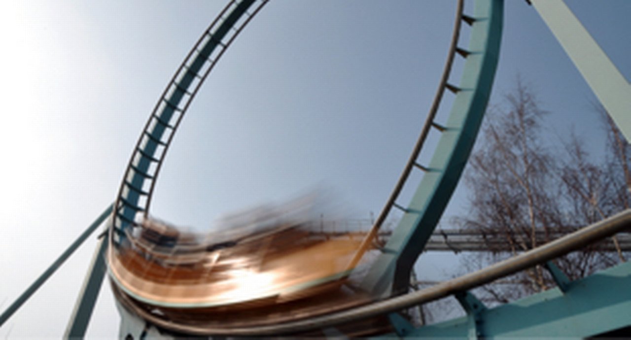A roller coaster in full motion climbing a loop