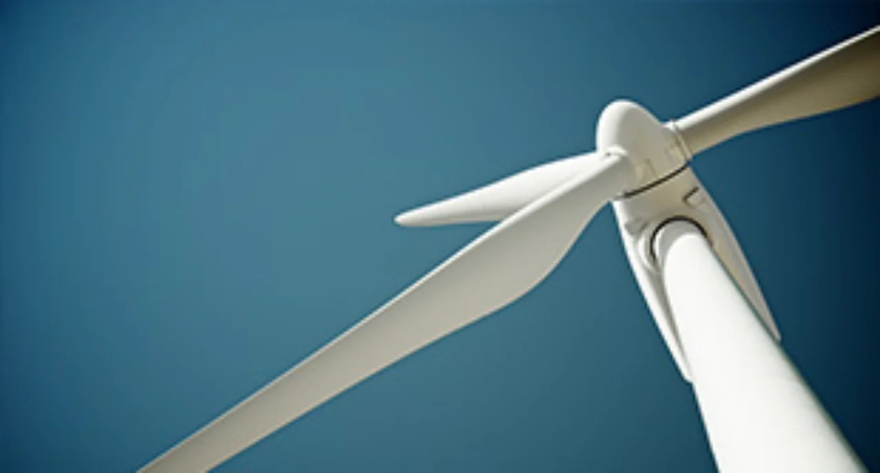 Close-up of a windmill against a deep blue background