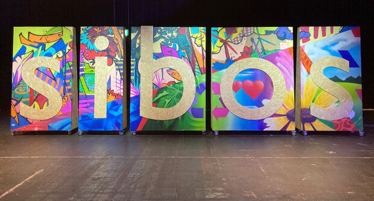 ${esc.q}sibos${esc.q} written on abstract paintings in a gallery