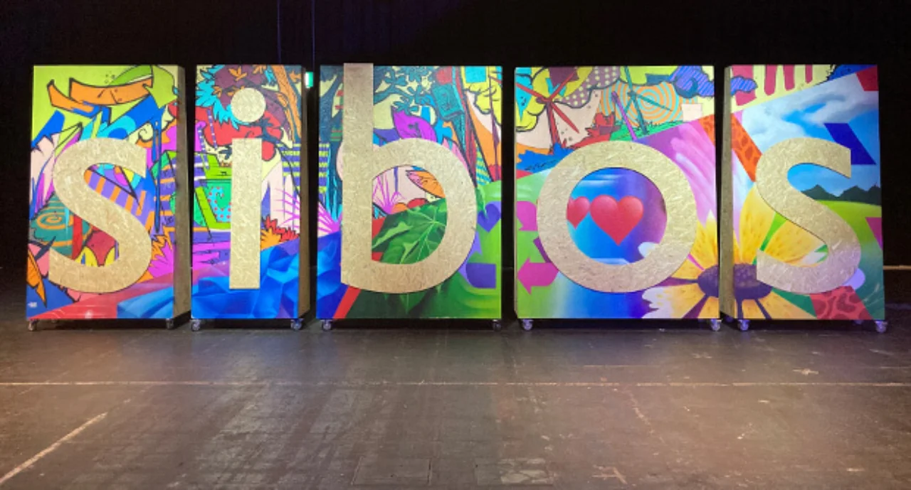 ${esc.q}sibos${esc.q} written on abstract paintings in a gallery