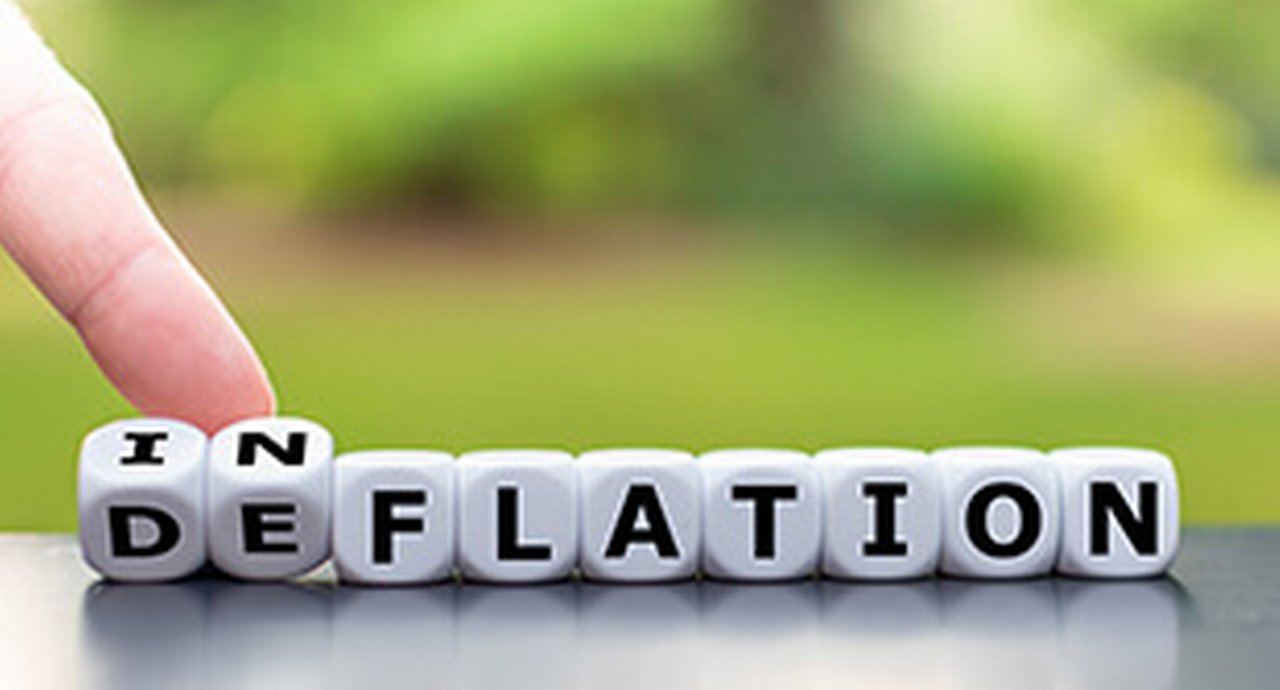 A row of cubes showing inflation, with the first two cubes rotated to show deflation