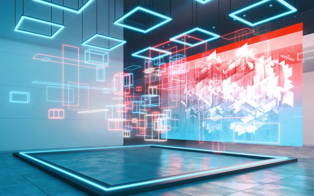 Art gallery illuminated by blue lights exhibiting a large display showing a digital geometric image and an installation made of bright floating blocks illuminating the space with neon colored lights.