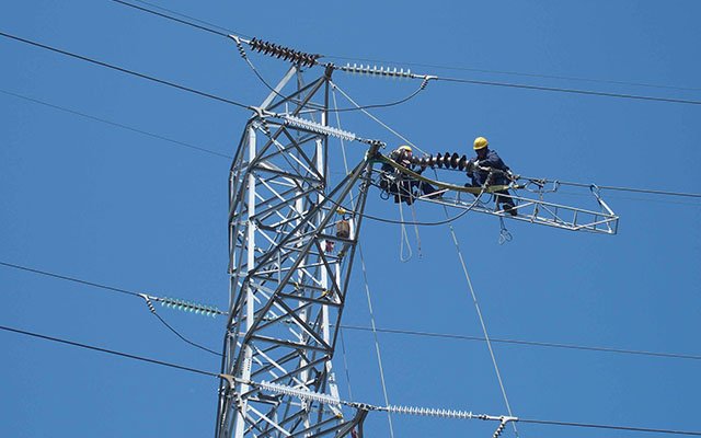 Man on an electricity pylon