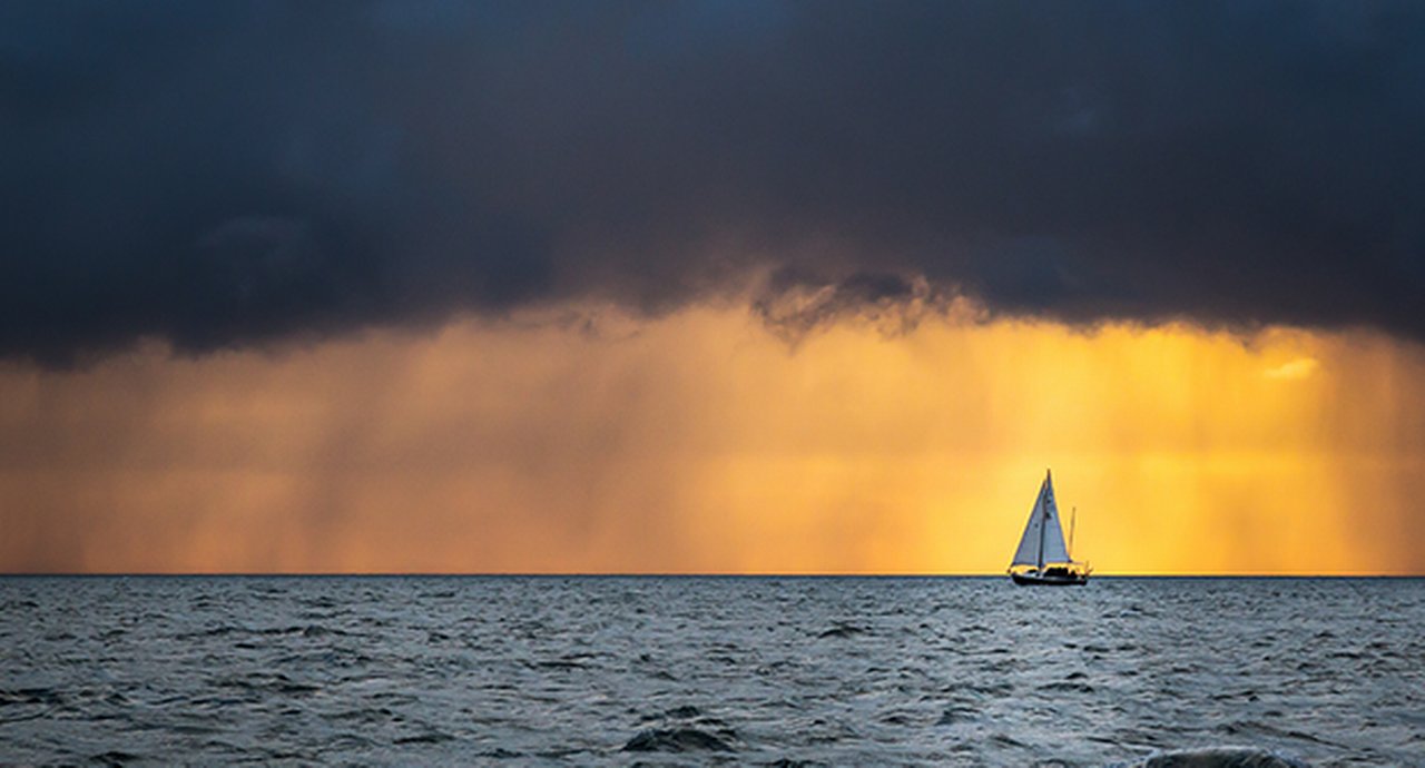 Boat Sailing Into The Storm
