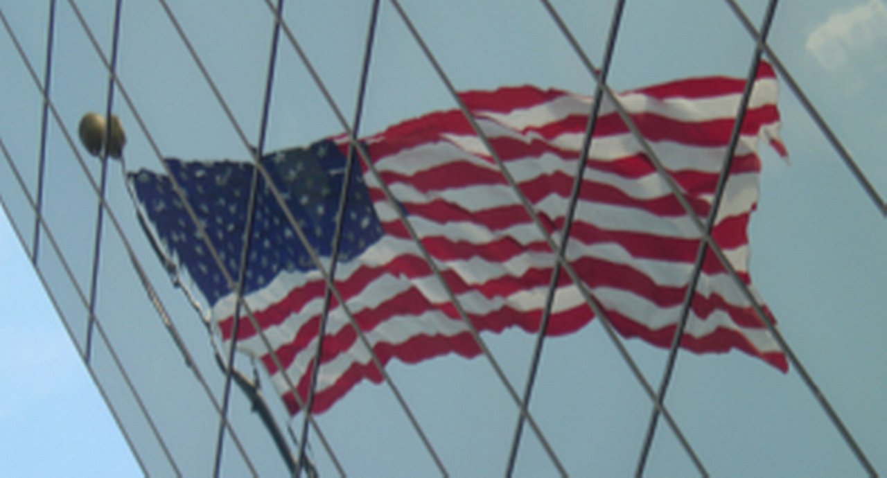 The American flag reflected on a skyscraper