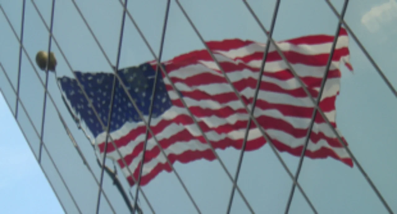 The American flag reflected on a skyscraper