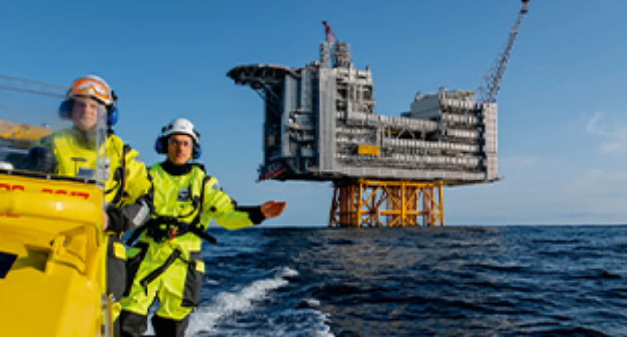 Two men driving away from an oil rig in the North Sea