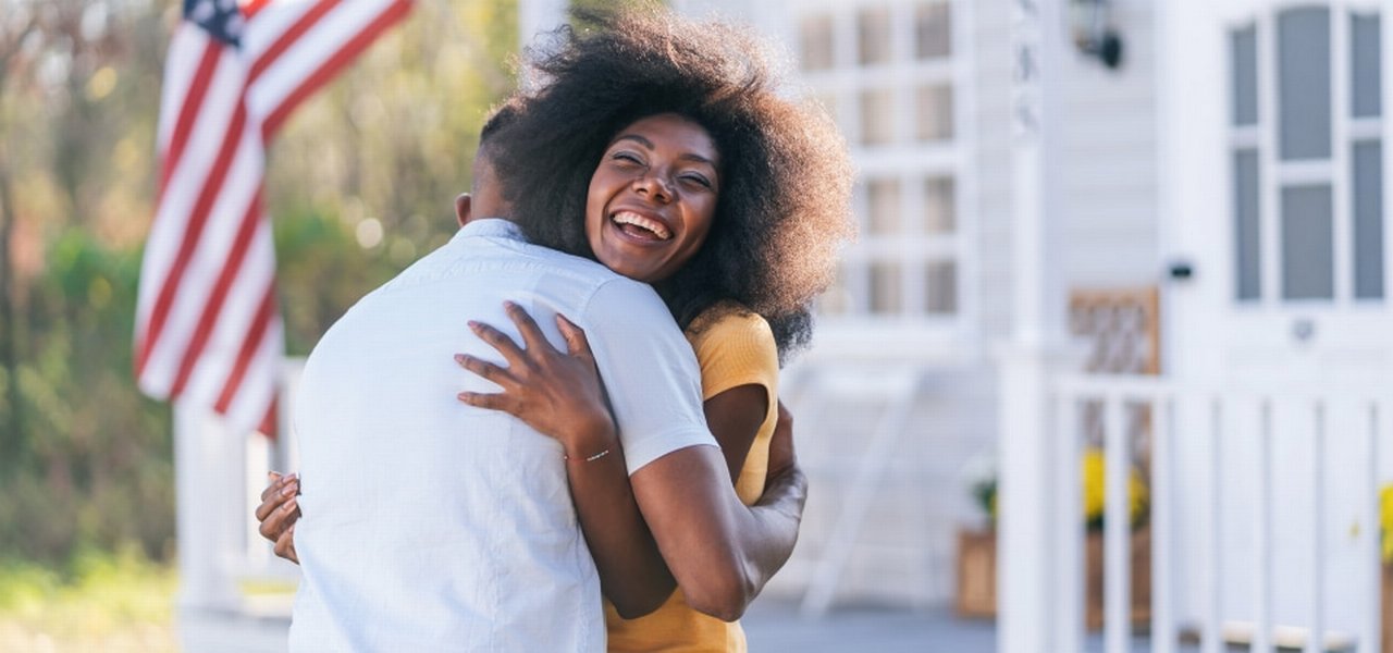 Woman Welcomes Her Husband On The Porch