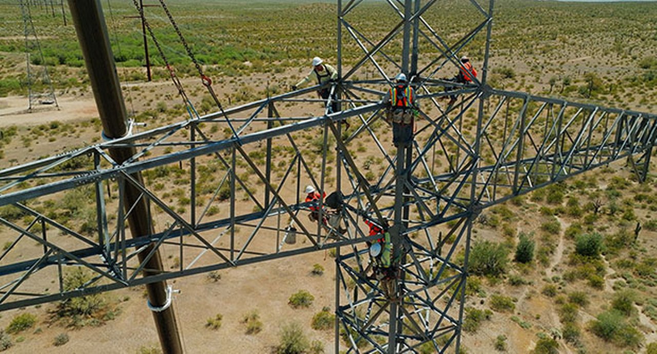 Electricians working on power lines