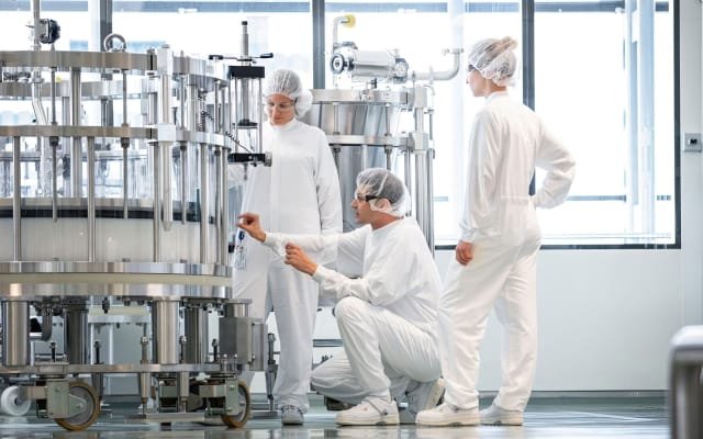 Lab workers checking lab equipment
